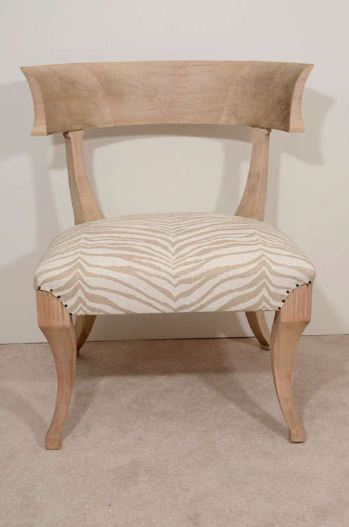 Fabulous animal print linen over a sun bleached mahogany frame. Wonderful curvature with sculpted carved wood details.