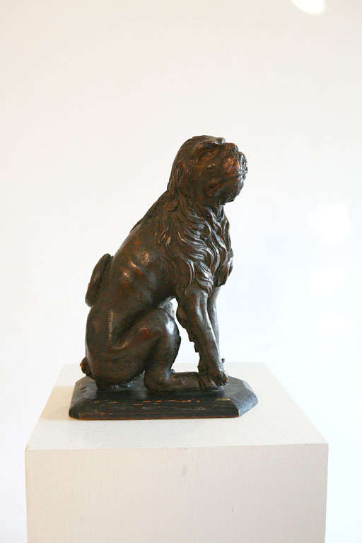 Lion is carved from walnut; On later wood plinth; Originally adorned a newel post.