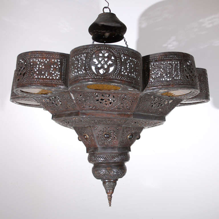 Moorish Style Moroccan chandelier with amber glass, finely  handcrafted with nice geometric designs. Antique brass metal.


We specialise in rare 18th and 19th century Moorish style Antiques, Moroccan, Middle Eastern, Islamic Art and African