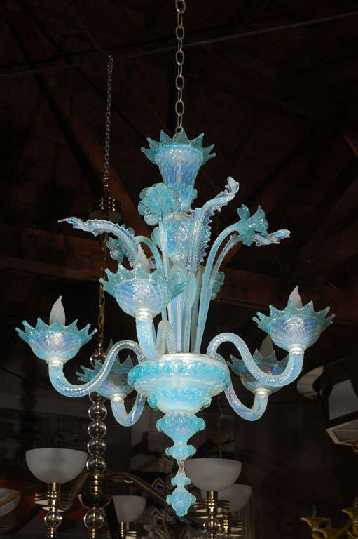 A beautiful Murano glass chandelier from the 1950's. Has five arms and is decorated with glass flowers and leaves.