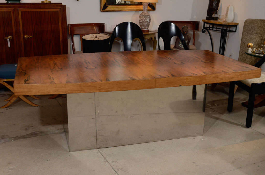 Midcentury Brazilian rosewood extension dining table on polished chrome base,
custom made by Eppinger Furniture Co. From the home of Jim Eppinger of
Carmel, NY. Fully bookmatched both when closed and extended. The extensions are stored within the