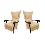 Pair of ebonized wood upholstered wing back armchairs