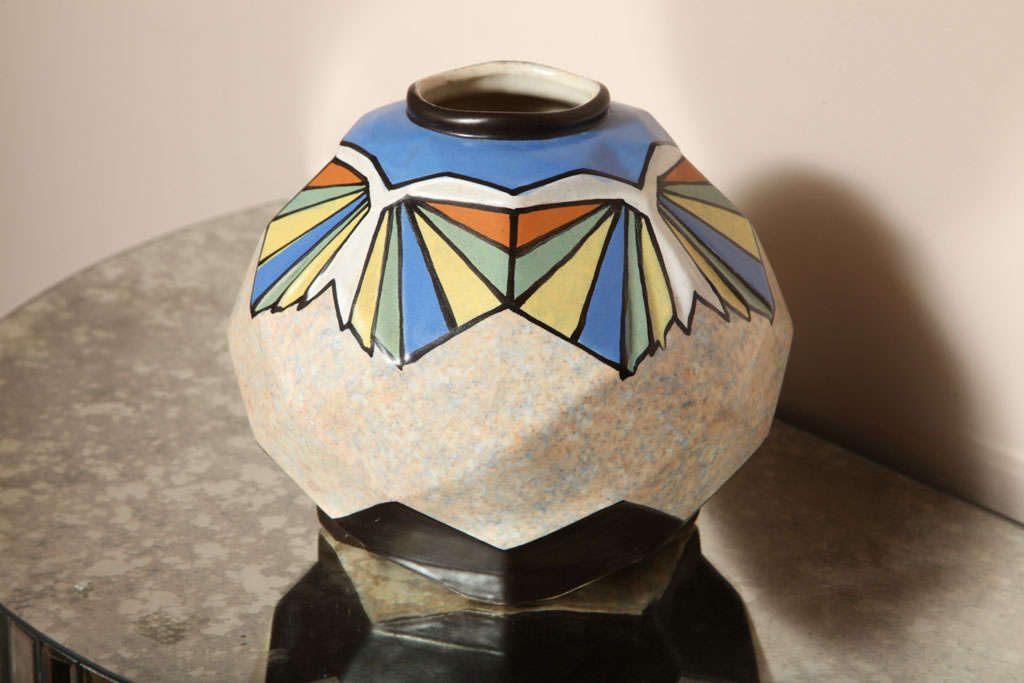 Hand painted modernist vase, signed by the Belgian artist A. Dubois, of cubist shape with blue, green, yellow, brown and white on a mottled background.  

Diameter: 9
