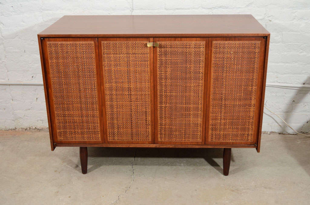 American, 1950′s, hand crafted, solid walnut sideboard with original cane front bi-fold doors.  There is a coordinating double dresser, pair of bedside tables and headboard available separately.