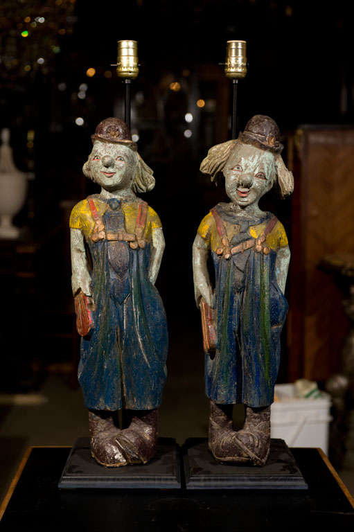A pr. of early 20th century carved wood carnival clowns with original paint.<br />
Presently converted into table lamps