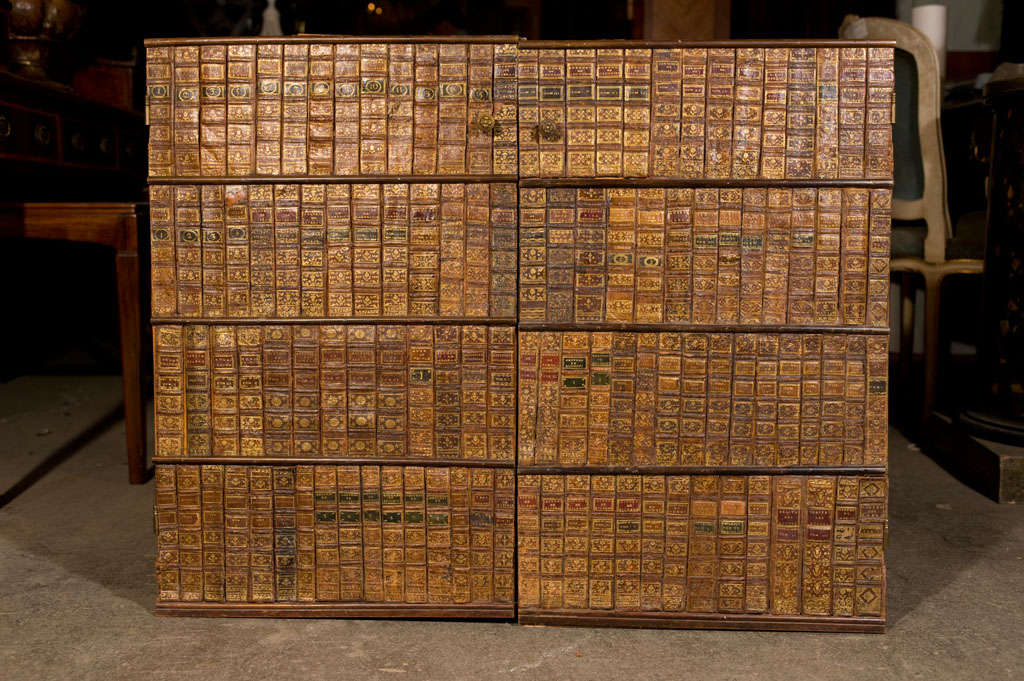 A pr. of panel doors covered with period 17th and 18th century leather book spines along with a pr. of drawer fronts with similar work. Approx. 56 book spines per door.
