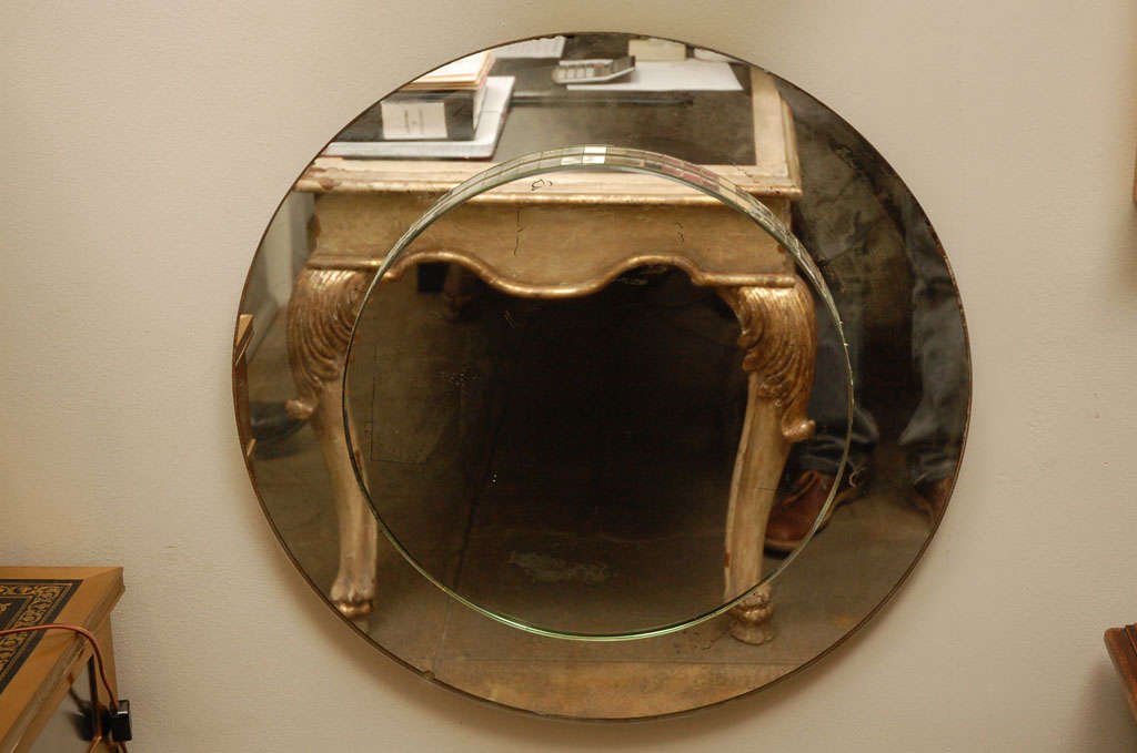 Tiered round mirror with mosaic mirror detail.