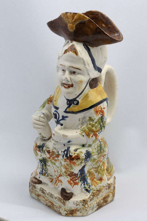 A fine English pearlware Martha Gunn toby jug with Prince of Wales feathers in her hat and decorated in underglaze Pratt colors