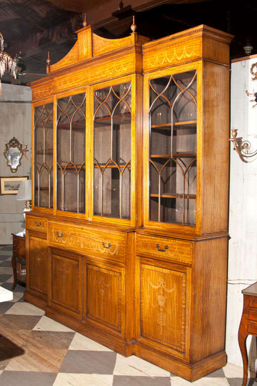 
satinwood and inlaid  secretary with 4  glazed  doors above a lower cabinet  with 4  doors, in 4 parts. flip down  butlers  desk in center.
