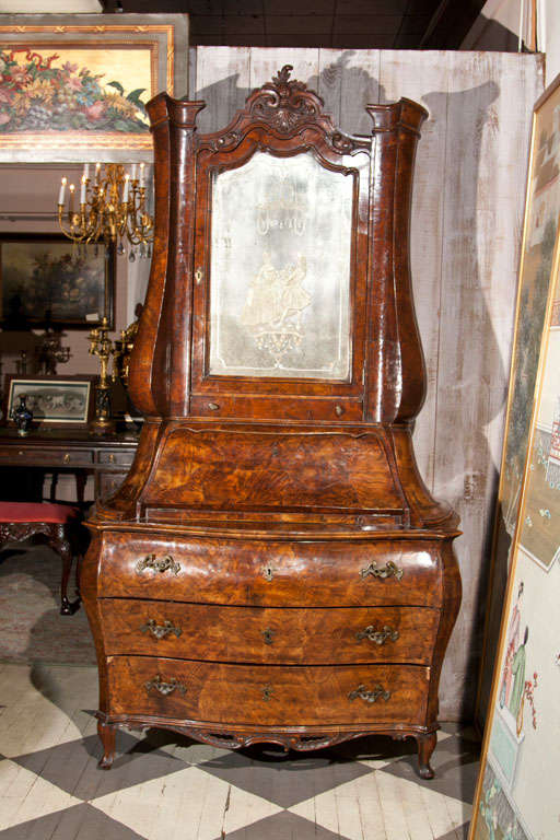 A 3 PART SECRETARY WITH BEAUTIFUL ETCHED MIRROR DOOR WITH A MALE AND FEMALE FIGURE IN ROCOCCO STYLE, THAT OPENS TO REVEAL  PAINTED  SURFACES, CUBBY HOLES AND SMALL DOOR,ABOVE A DRAWER,ABOVE A SLANT  FRONT  LID THAT OPENS TO REVEAL  A WRITING SURFACE