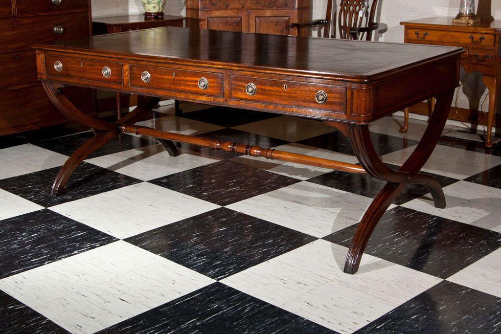 Handcrafted for us by a small workshop in England, this writing table embodies the quality and appearance buyers of bespoke English furniture have come to expect over the last 300 years. From the gold-tooled leather to the rich, hand-rubbed finish