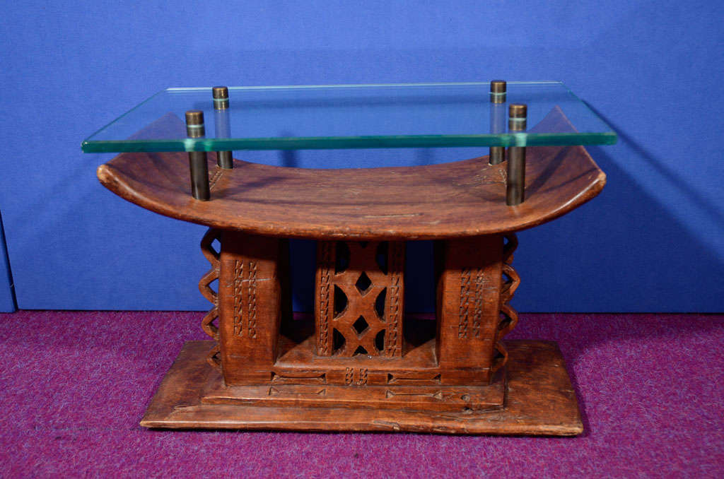 Beautiful low stool carved from one piece of wood.  Bronze mounts and a thick glass top convert this stool into an interesting side table.  *To see our entire inventory, please visit www.donzella.com
