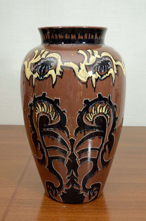 Large vase form with glazes in brown, black, cream and white. Vibrant, abstract pattern decoration. Signed on underside.