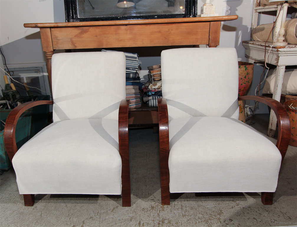 perfection... chairs are completely rebuilt using our private stock french vintage linen...crushed walnut arms... perfect in a master, or library... sold and priced as a pair.<br />
<br />
photos provided by 1stdibs