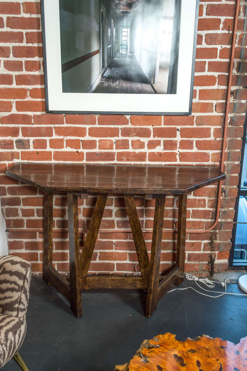A pair of distressed, stained, and varnished walnut demilune tables from the 1990s.