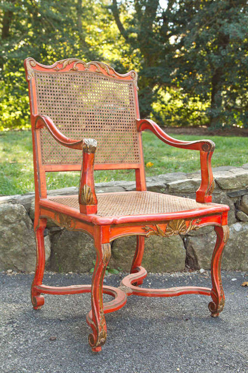 Italain Carved and Painted WOod Armchair, painted a rich and warm orange with gilt details in relief.