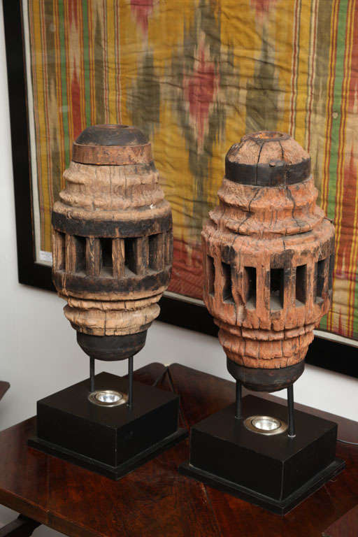 Sugar grinder hub lamps with iron rings, each on a stand with inset light which shines through core.  Sold separately.