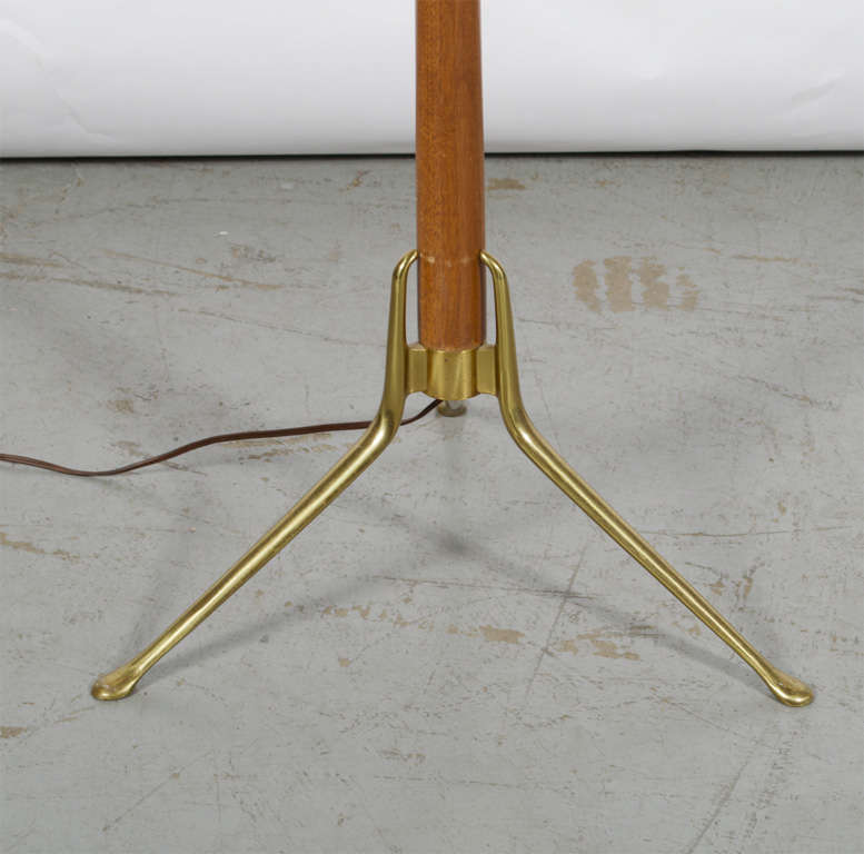 Gerald Thurston floor lamp by Lightolier. Features a brass and walnut base and a perforated brass shade. Measures: 17