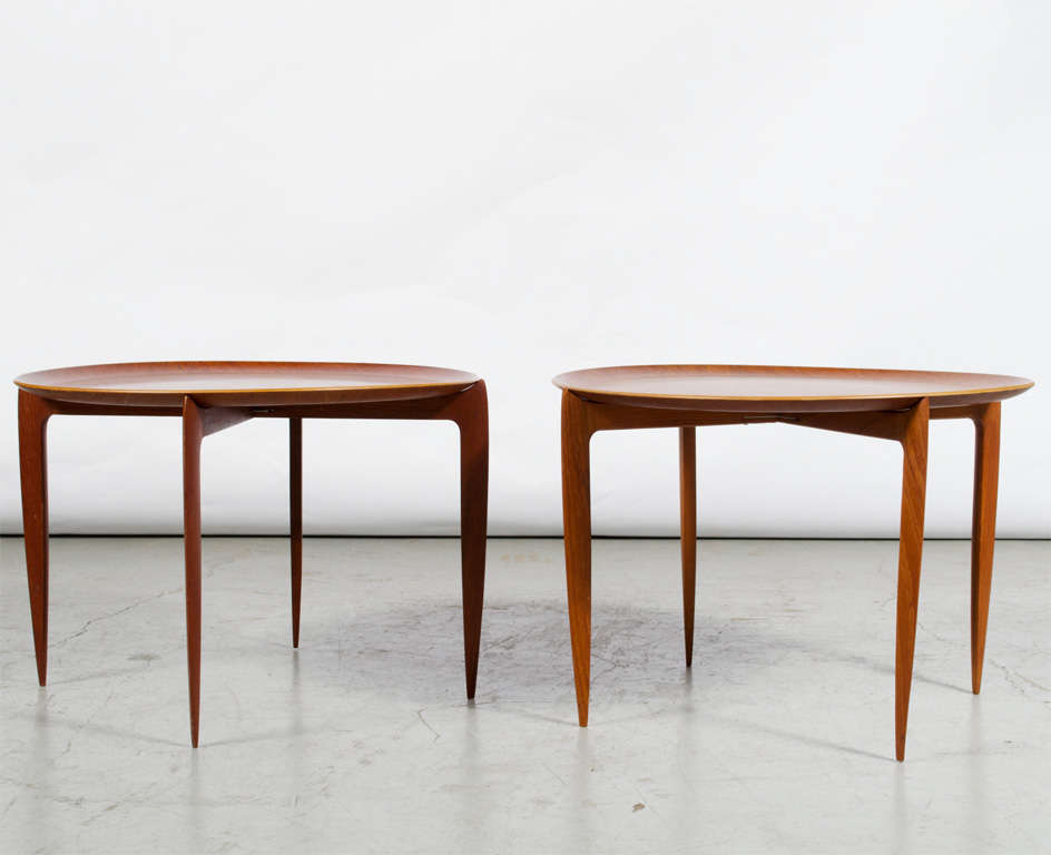 A pair of Fritz Hansen tray tables designed by Svend Aage-Williamson & H. Engholm with removable teak trays on tapered teak folding legs. Made in Denmark. Signed.