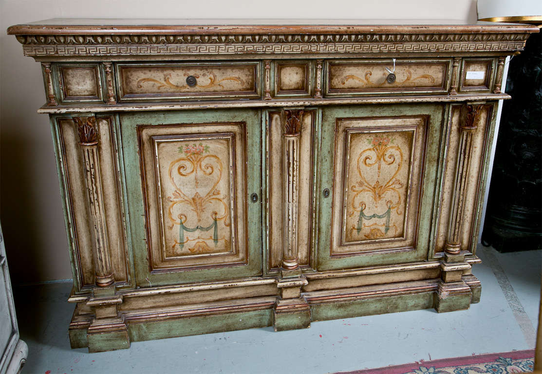 Italian distress-painted and hand-drawn credenza cabinet or buffet, 20th century, the rectangular top over a greek-key decorated motif over a narrow frieze fitted with two drawers, over a conforming two-door cabinet opens to shelving interior,