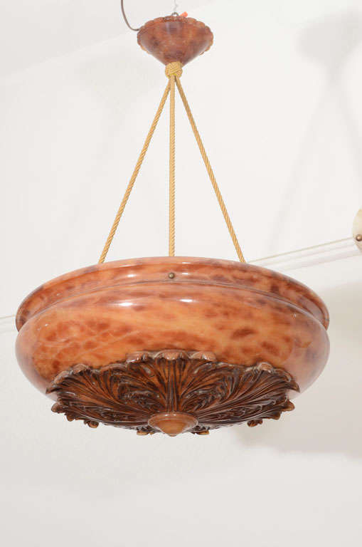 A neoclassical, amber toned alabaster fixture, reflecting the formal style of the interiors at the end of the 19th century, the light features acanthus leaf carvings surrounding a central disc and a delicate, decorative canopy.

Custom rewiring to