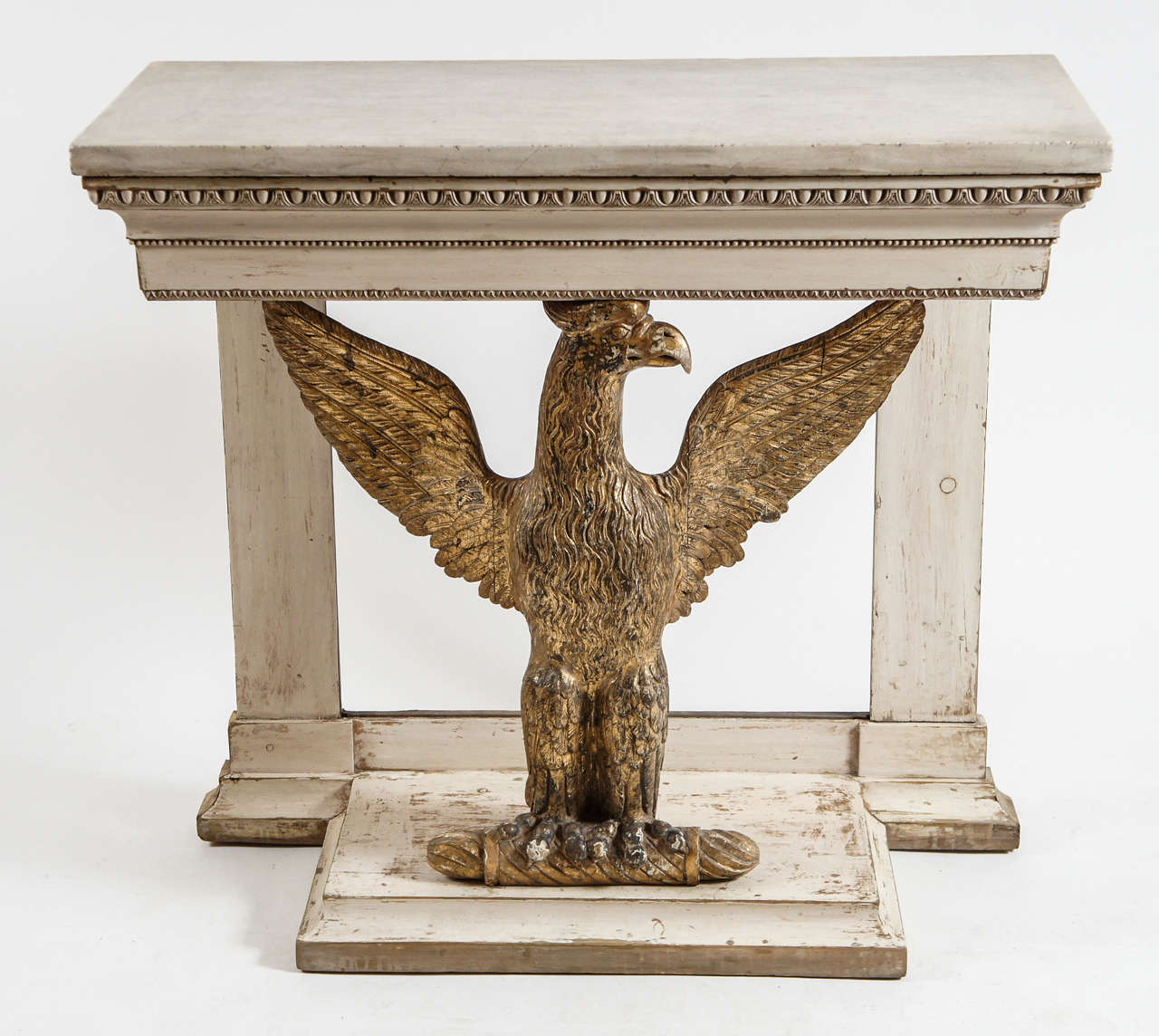 Swedish late Gustavian period c. 1800 console table having large masterfully carved gilt wood spread-winged eagle front support below original top of white statuary marble surmounting apron with variant egg-and-dart motif filet border.  Original