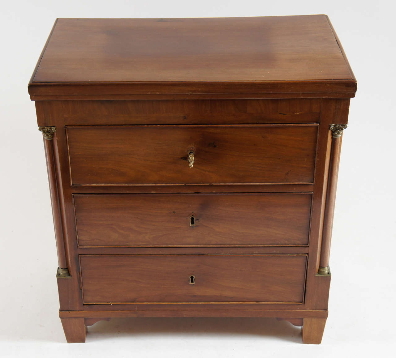 Danish Louis XVI style three-drawer mahogany commode or chest of architectural form having engaged corner colonettes with lost wax cast gilt bronze Corinthian capitals and bases, circa 1790. Original working key included.

Additional search terms: 