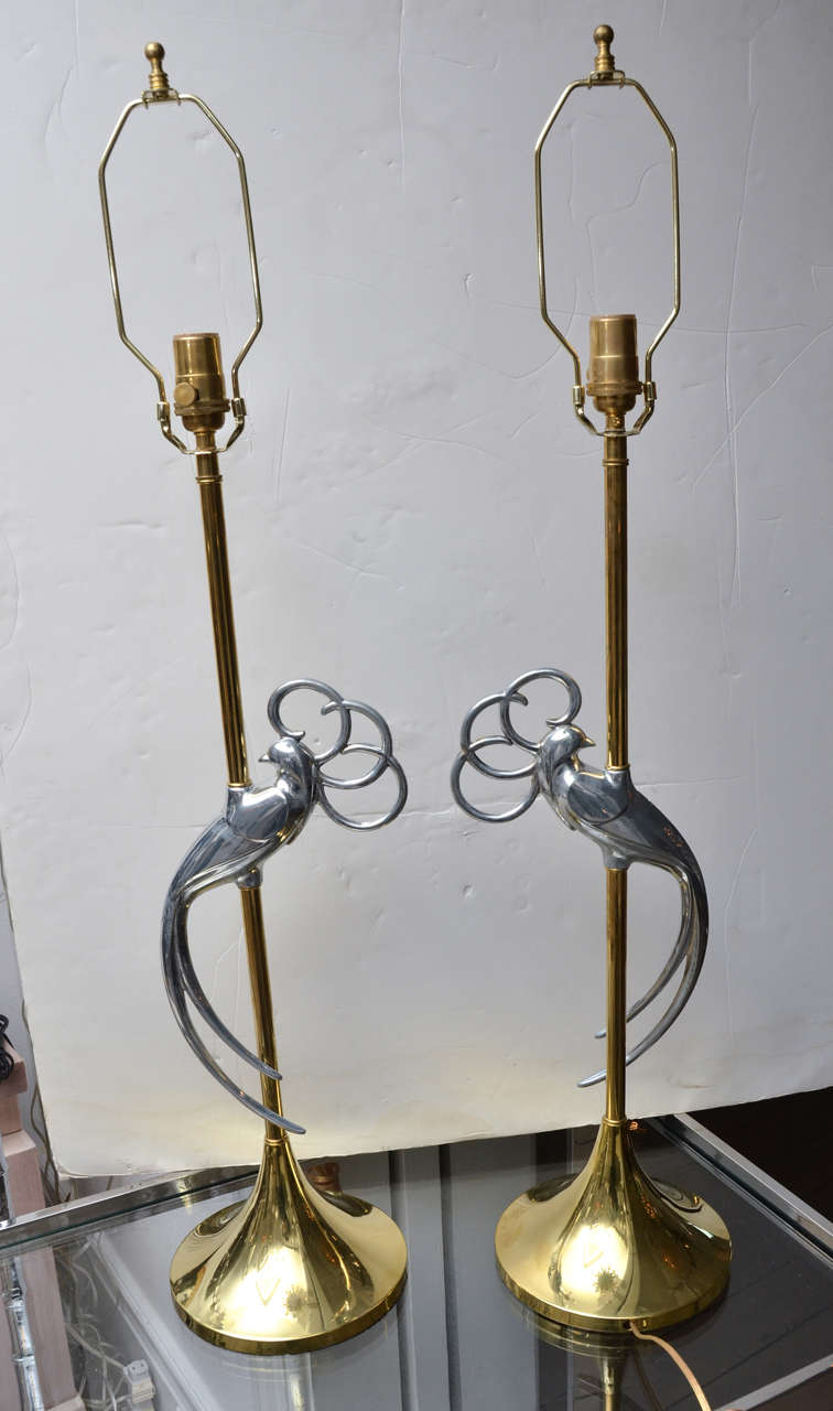 Pair of brass table lamps with stylized chrome exotic bird at centre.