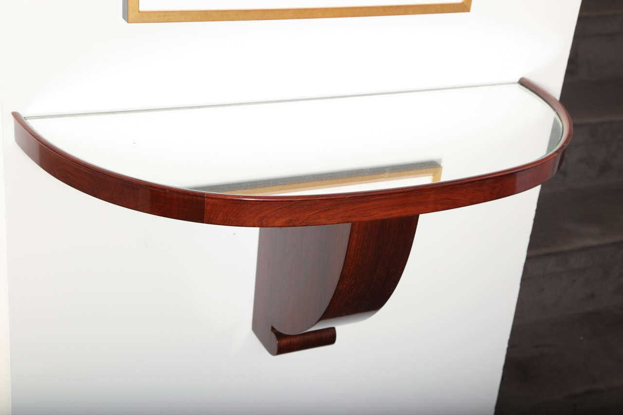 Demi-lune console in mahogany with a mirrored top by Jules Leleu