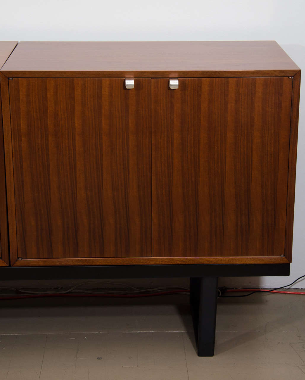 Pair of George Nelson cabinets on black bench, mfg. Herman Miller In Excellent Condition In New York, NY