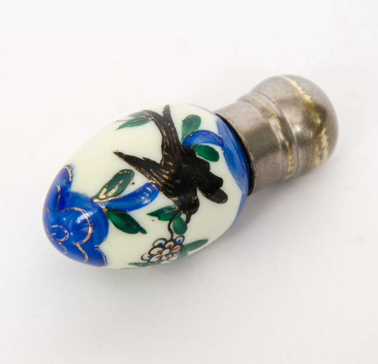 This is a fine perfume bottle by James Macintyre & Co. of Burslem, England.

The porcelain bottle is in the shape of an egg with a pewter screw cap top.

The bottle is beautifully hand enamelled with birds in a floral woodland setting, with