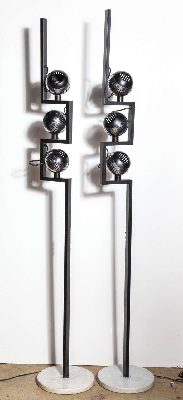 Single Angelo Lelli for Arredoluce Chrome, Black & Marble Floor Lamps with Three Chrome Eyeball Shades. Circa 1970. Featuring rectangular Black enameled steel shaft with three adjustable magnetic mounted and vented Chrome globe shades. On round