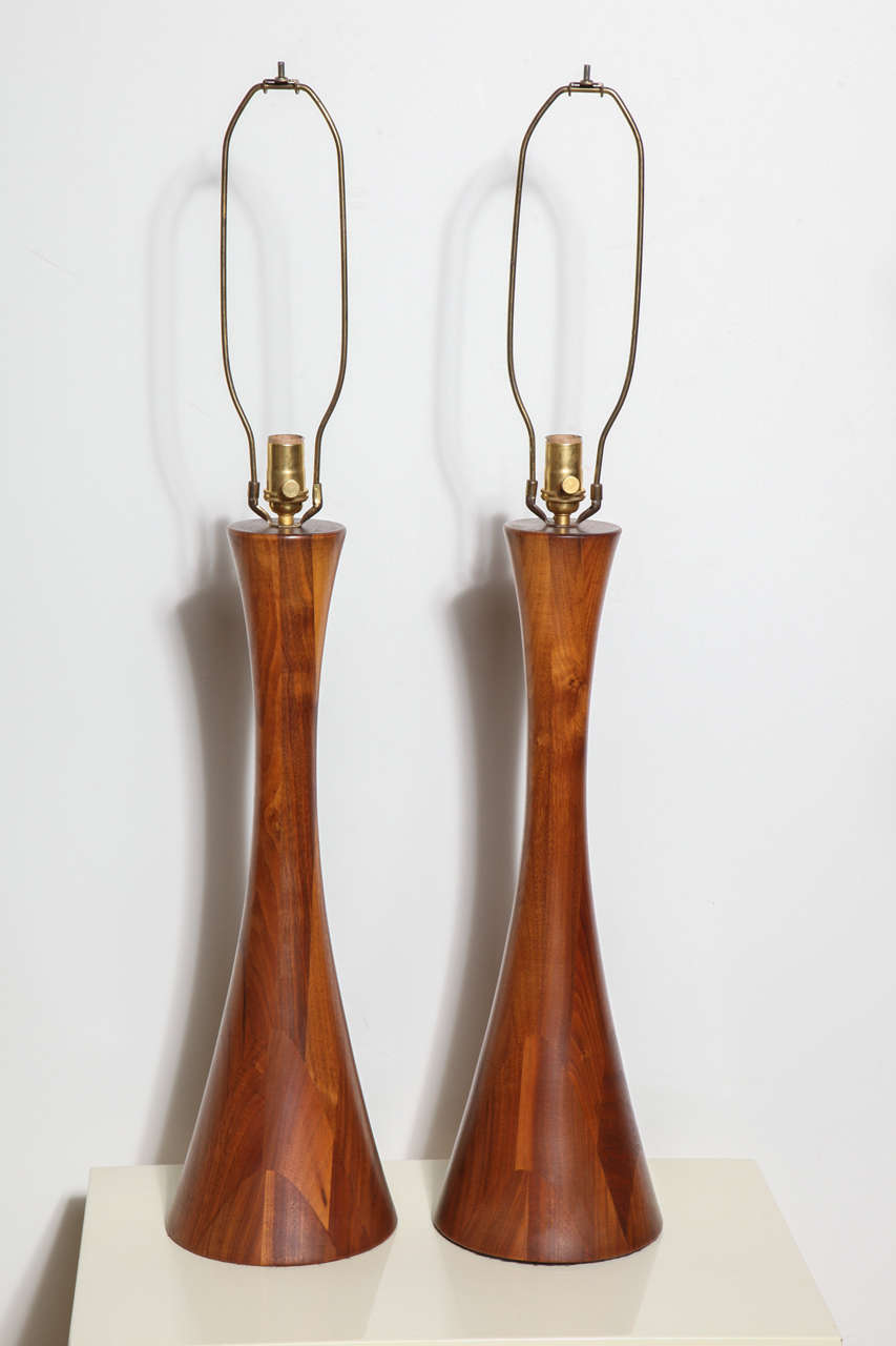 circa 1975 pair of tall Phillip Lloyd Powelll Solid Turned Walnut Hourglass Lamps.  Rewired with new Brass hardware and twisted cloth cord