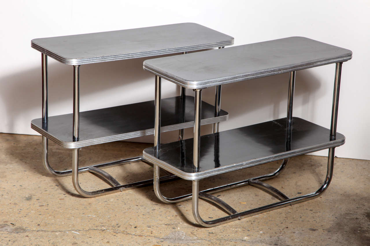 2 streamlined rectangular Wolfgang Hoffmann style Art Deco Royal Chrome End Tables or Bookcases.  With  rounded tubular Chrome framework, Black Micarta Top and lower Shelf and rounded Aluminum rim.  Perfect for compact or small space.  Great for use