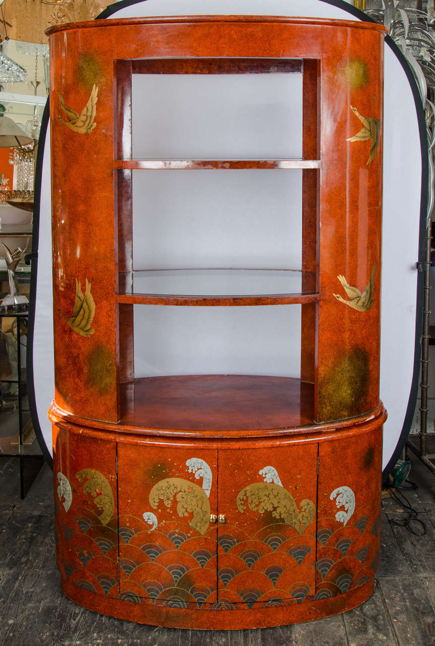 A 1920s French red lacquer display cabinet or bar, with Japanese style, designs of birds and sea waves.