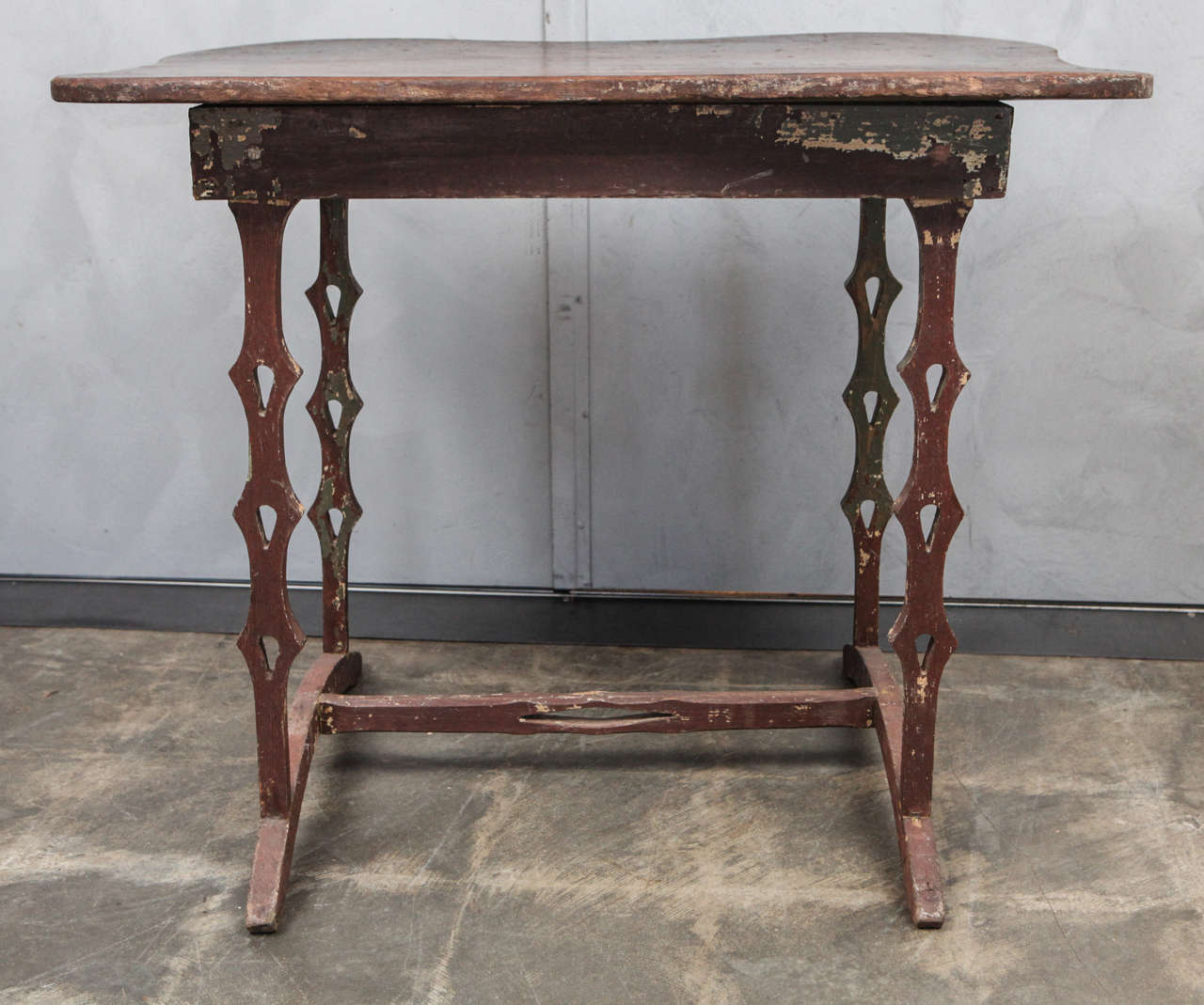 This wonderful little table shows influences of Scandinavian design motifs with the wonderful cut-out in the legs and stretcher. The is also a nod to European design movements with the interestingly shaped curved feet. The table has a nicely shaped