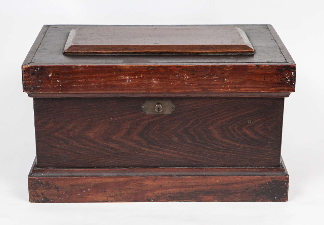This carpenter's box has a stepped top and three removable trays. The box has brass hinges, lock and bracket and iron handles. This piece has great character with signs of use and is full of history.