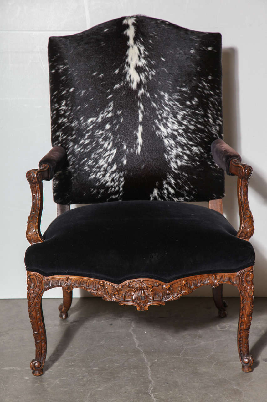 19th century large English Regency chair with beautifully carved mahogany. Pony hair back, velvet seat and arms.