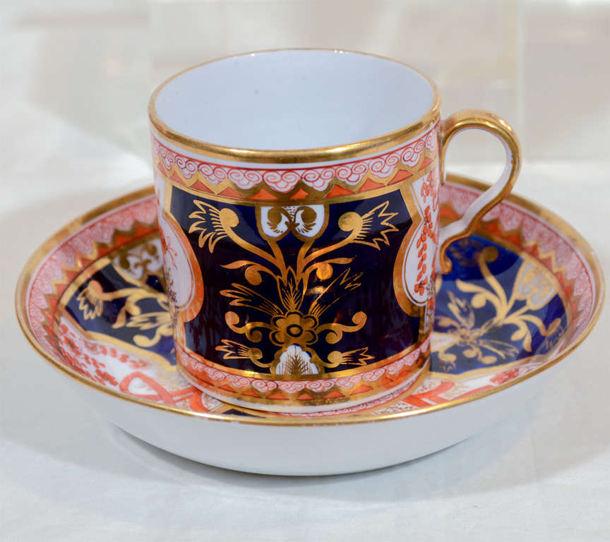 Painted in Spode's Dollar pattern, pattern 715, the group comprises: a dozen coffee cans and 4 tea cups and their saucers. The 