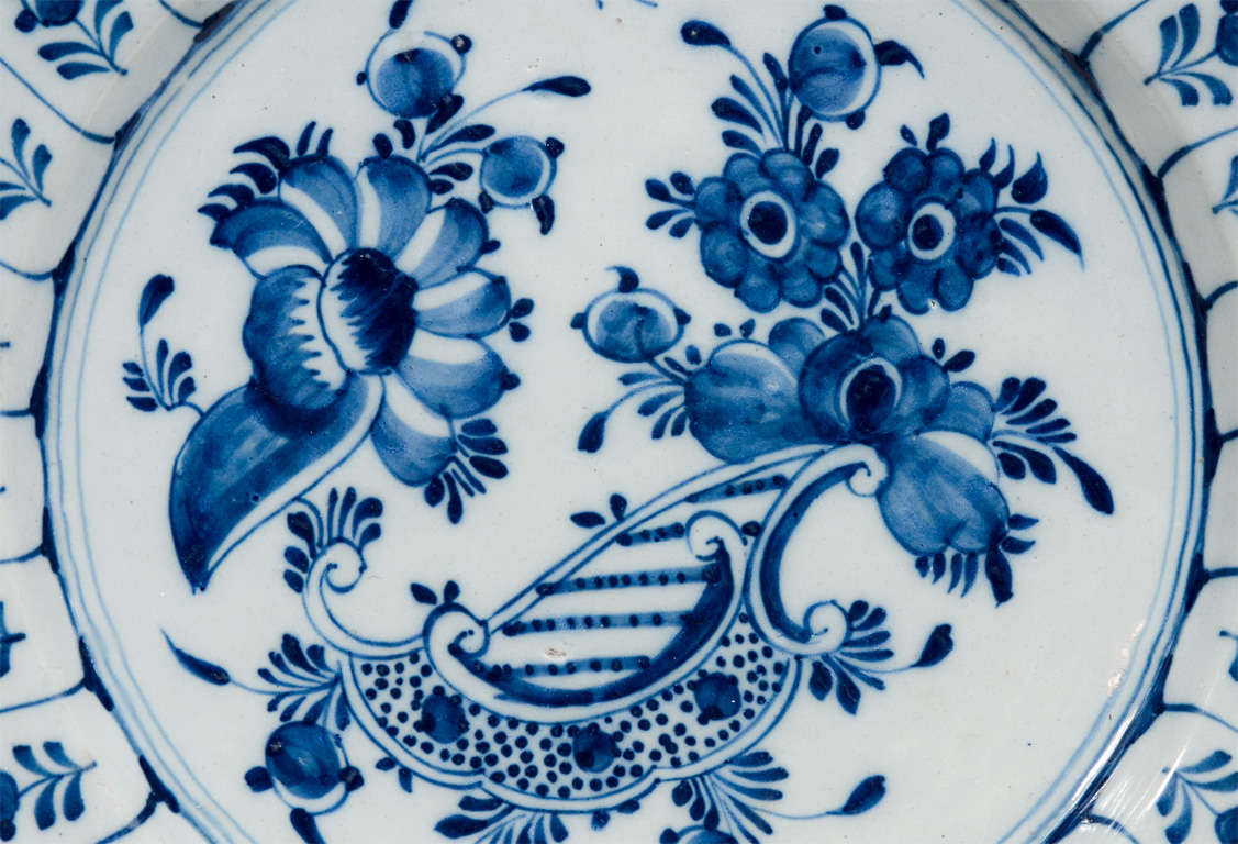 Provenance: From the collection of Katherine Mellon 
A pair of Dutch Delft Blue and White chargers showing flowers in the center surrounded by a wide band of flowers in cartouches.