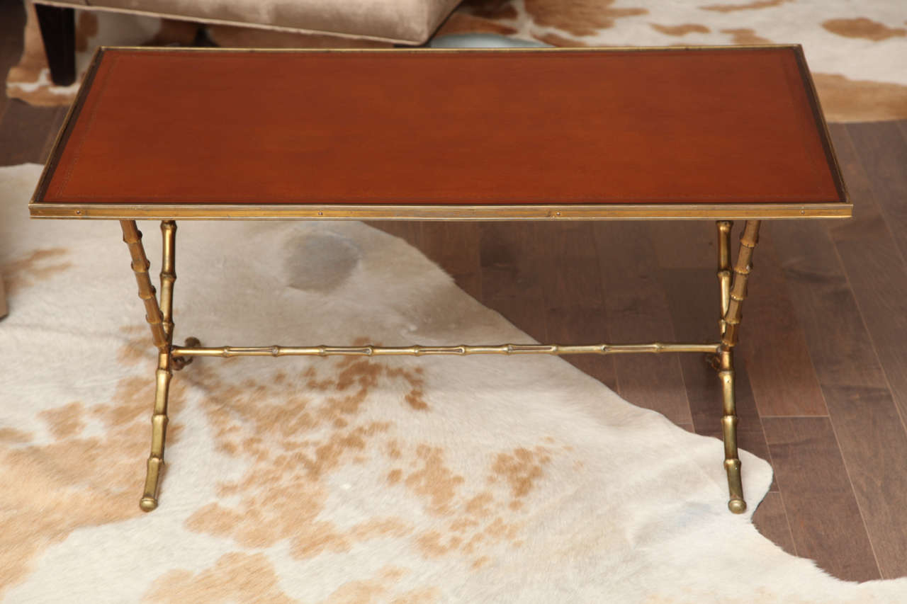 Leather top cocktail table with faux brass bamboo base in the style of Baques, c. 1950