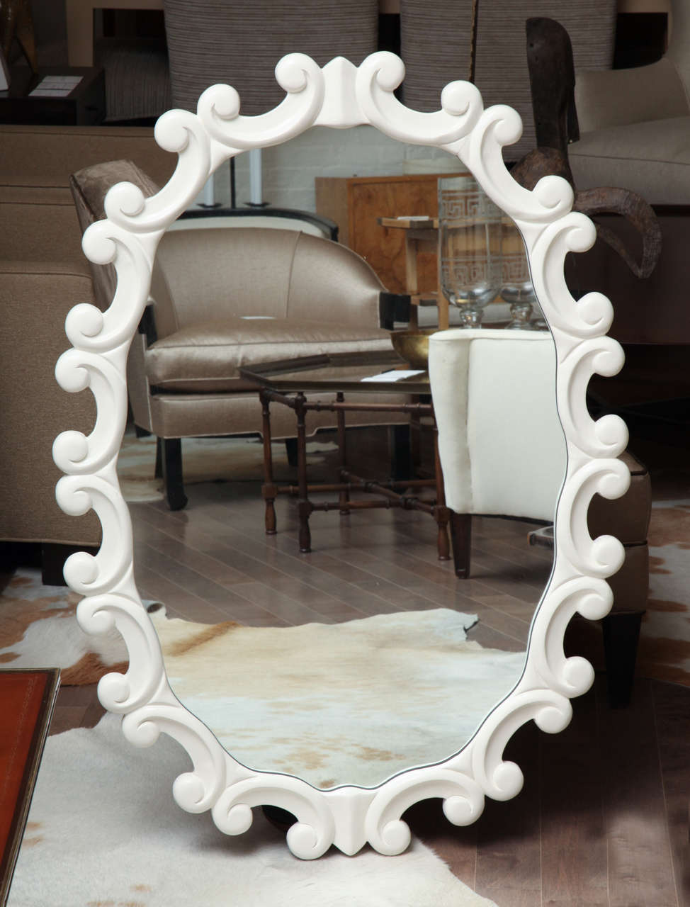 Pair of white lacquered faux Regency oval mirrors, circa 1940.