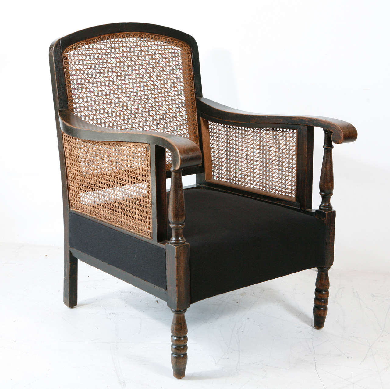 Striking Italian chairs with perfect condition cane back and arms newly reupholstered in black hemp linen. Sold individually.