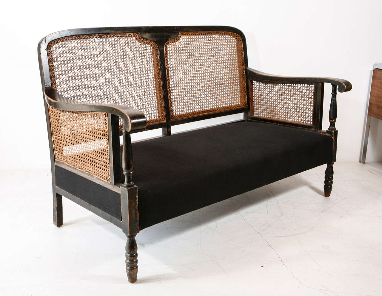 Striking Italian sofa with perfect condition cane back and arms newly reupholstered in black hemp linen.