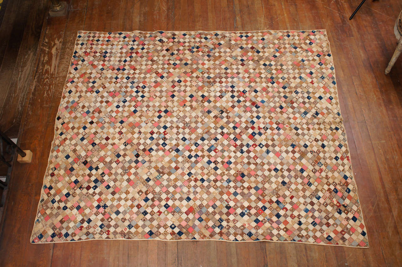 American postage stamp quilt. Comprising 1.25" squares
sewn to make up the entire quilt.  From a distance looks
like pointilism.  Painstaking patience to have put this
together.  Small repair to bottom edge.