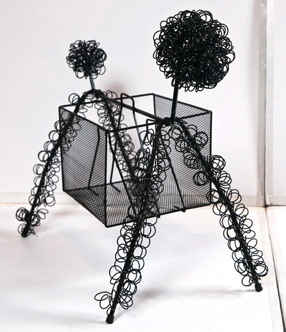 Mid-century abstract wire poodle magazine holder.