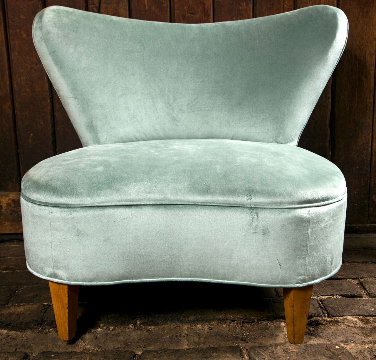 Newly reupholstered in blue/grey cotton velvet, 1940's glamorous slipper chair.