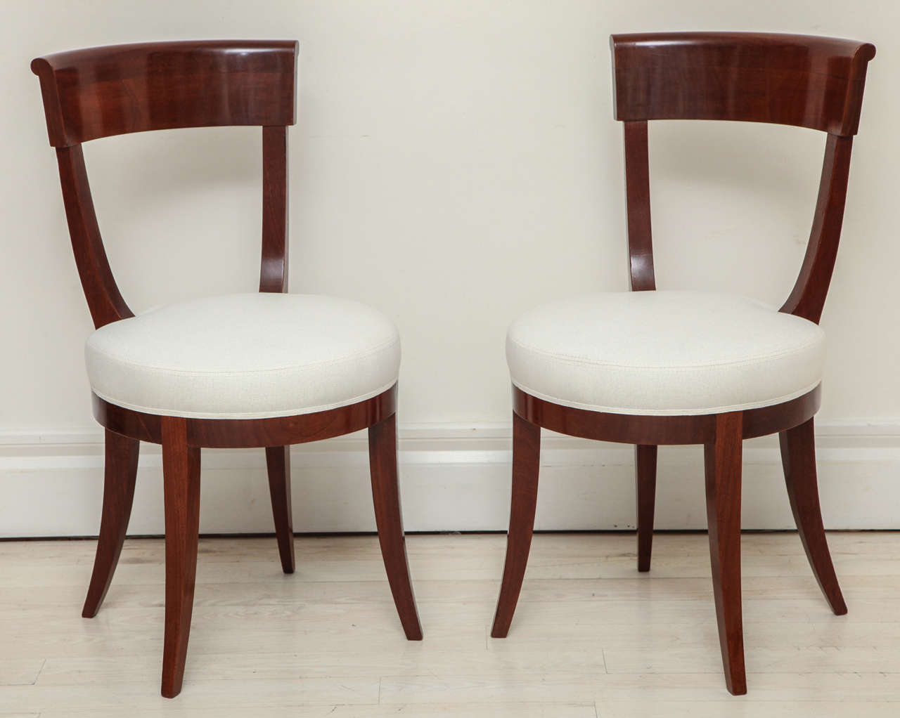 French walnut chair with  a curved back and round, newly upholstered seat.