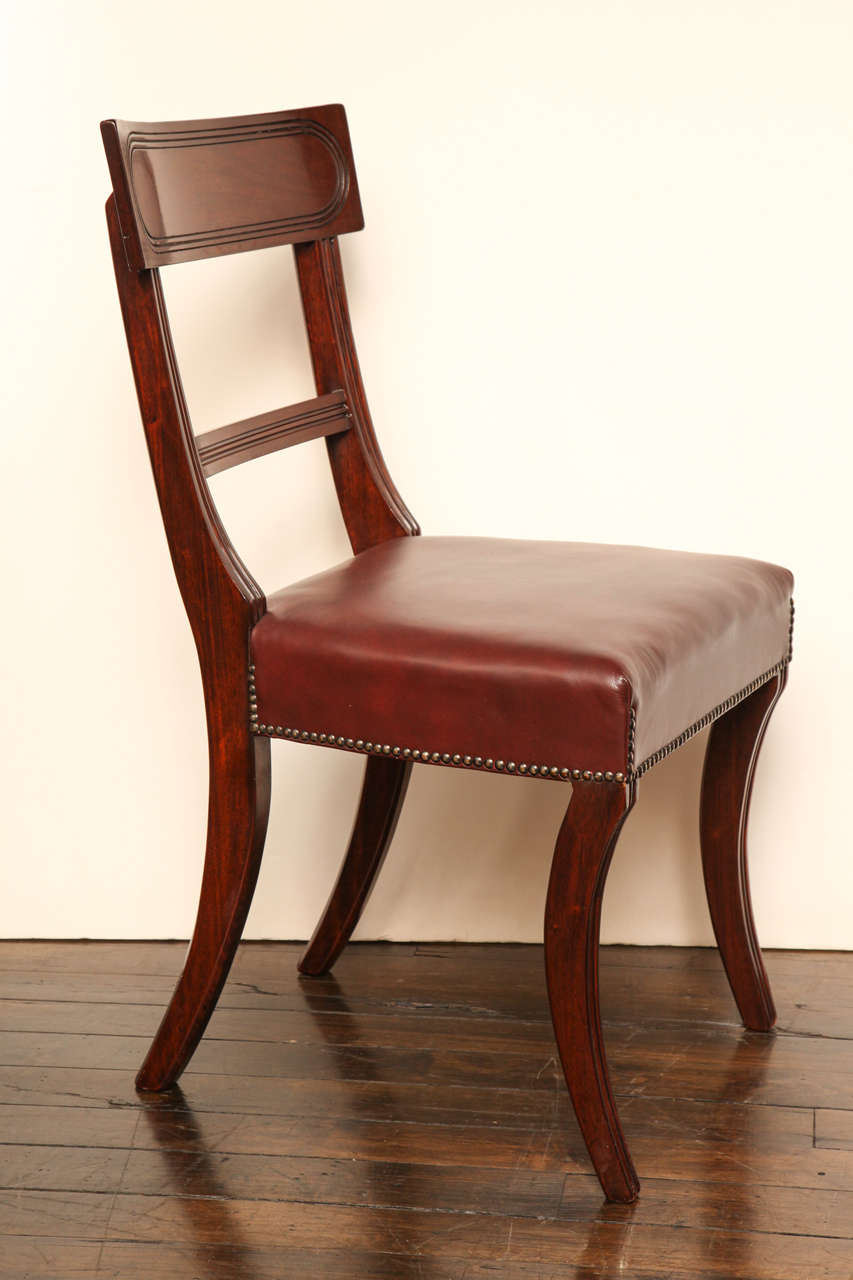 Set of eight 19th century English neoclassical mahogany dining chairs.