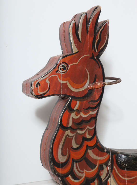 from primitive 19th century carousel Reindeer children's ride.  Made of stacked wood and painted in traditional Pennsylvania German Folk Art manner with forged iron handle.  This has an outstanding Folk Americana presence.  Great for holiday display.
